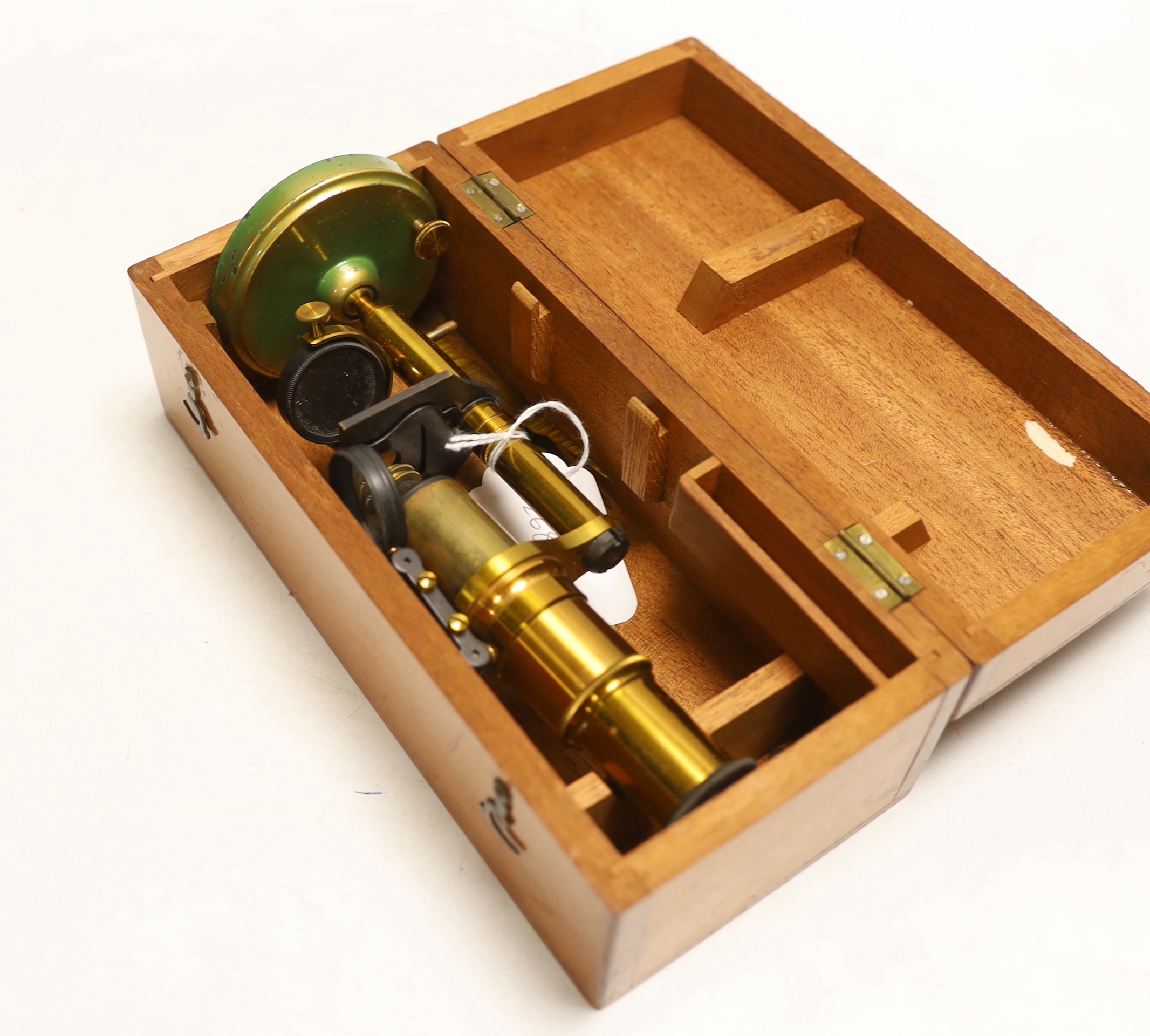 A brass monocular student’s microscope in fitted teak case, case 22cm